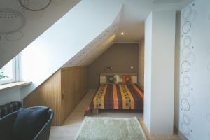 a bedroom with a bed in a stair case at Arina Guest Apartment in Kuressaare