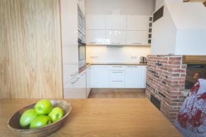 a kitchen with a bowl of apples on a table at Arina Guest Apartment in Kuressaare