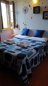 Postel nebo postele na pokoji v ubytování Notti Etrusche a Sovana