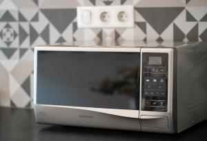 a microwave oven sitting on top of a table at Baross Boutique Apartman in Győr