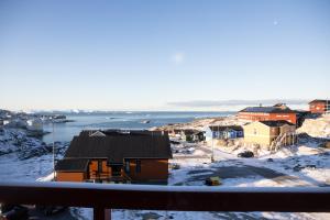 a view of a town in the snow at HOTEL SØMA Ilulissat in Ilulissat