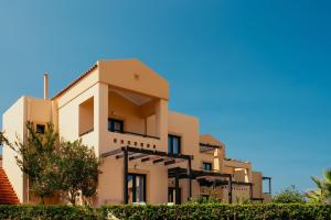 a building in front of a blue sky at Silver Beach Hotel & Apartments in Gerani Chanion
