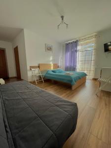 a bedroom with a bed and a desk in it at Yaremche House in Yaremche