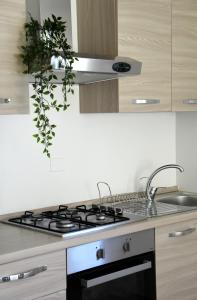 a kitchen with a black and white stove top oven at Villa al Mare in Bellaria-Igea Marina