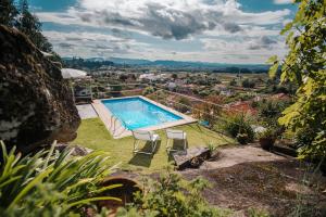 a swimming pool on the side of a house at Casa da Serra in Viana do Castelo