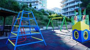a playground with a ladder and a swing set at Плажни Апартаменти Силвър Бийч - Silver Beach Sea Apartments in Byala
