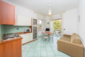a kitchen and living room with a couch and a table at La Residenza Aparthotel in Maiori