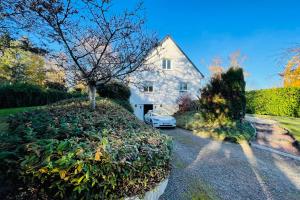 a white car parked in front of a house at The House of the Green Way a charming pied-à-terre for your walks in Toura in Joue-les-Tours