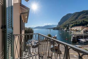 a balcony with a view of a body of water at Hotel Du Lac Menaggio in Menaggio