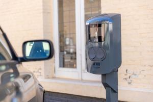 a parking meter in front of a car at Atlas Hotel in Valkenburg