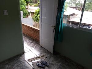 an open door with a pair of shoes on the floor at jazmin apart iguazu in Puerto Iguazú