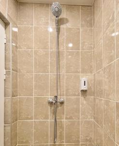a shower with a shower head in a bathroom at Elegant Studio for 4 Persons in Center & Parking in Stara Zagora