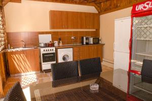 a kitchen with a table and chairs in it at Casa Andu in 2 Mai