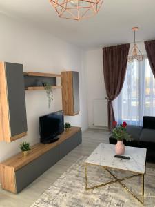a living room with a couch and a tv at Luxurious & Cozy apartment in Bucharest
