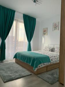 a bedroom with a bed with green sheets and a window at Luxurious & Cozy apartment in Bucharest +23 photos