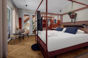 a bedroom with a large bed with a wooden frame at Villa Noordzee in Renesse
