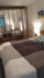 a hotel room with two beds and two chairs at Birkenstraße 15b Whg 13 in Zingst