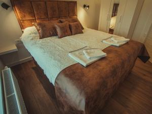 Postel nebo postele na pokoji v ubytování APARTMANI INFINITY
