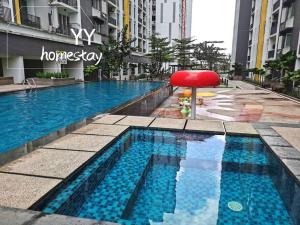 a swimming pool with a red chair next to a building at Designer Muji Penthouse Johor Bahru/Paradigm in Johor Bahru