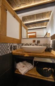 a bathroom with a sink and a counter with towels at Mon Petit Cervin in Valtournenche