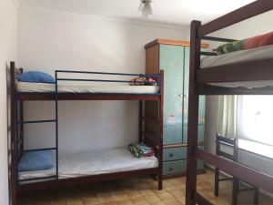 a room with three bunk beds in a room at Hotel Pousada Liberdade in Pindamonhangaba