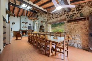 a dining room with a wooden table and chairs at Can Soler de Merlant in Porqueres