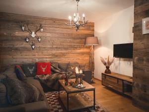 a living room with a couch and a table at Chalet on the Rood Zell am See Kaprun in Piesendorf
