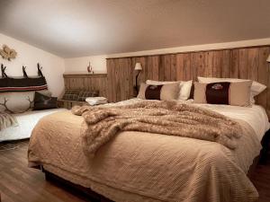 a bedroom with a large bed with a fur blanket at Chalet on the Rood Zell am See Kaprun in Piesendorf