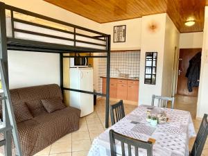 a living room with a table and a bunk bed at Studio au pied des pistes avec vue imprenable sur la station in Orcières