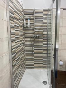 a shower with a glass door in a bathroom at La casa di Francesca in Campobello di Licata