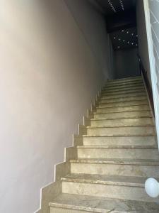 a staircase in a building with a white wall at La casa di Francesca in Campobello di Licata