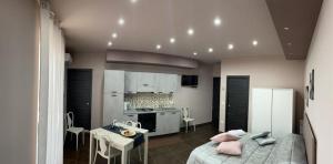 a living room with a bed and a kitchen at La casa di Francesca in Campobello di Licata