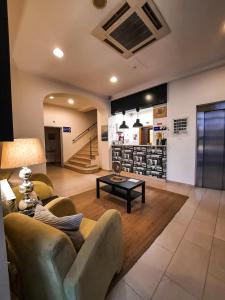 a living room with a couch and a table at Hotel Vila Verde in Castro Verde