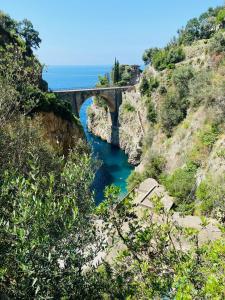 a bridge over a river next to the ocean at Tenuta La Picola in Furore