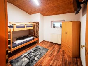 a room with two bunk beds and a wooden floor at Alpenchalet Dona in Partenen +22 photos