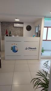 a counter in a kitchen with a clock on the wall at La Veranda Hotel in Larnaca