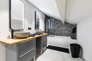 a bathroom with a sink and a tub at Le relais de Frilou 73 in Bourg-Saint-Maurice +7 photos