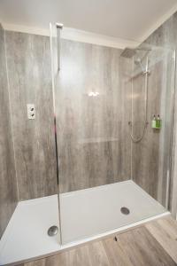 a shower with a glass door in a bathroom at Crown Lodge Hotel in Wisbech