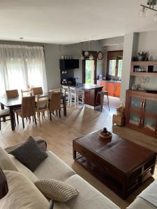 a living room with a couch and a table at Acogedora Casa en Asturias in Candamin