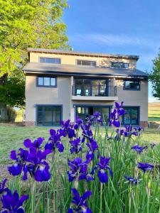 a house with purple flowers in front of it at Valley Lakes THE LODGE in Underberg