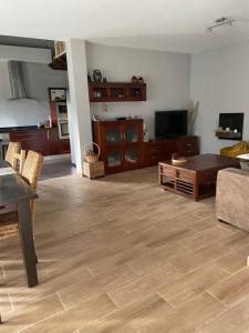 a living room with a couch and a table at Acogedora Casa en Asturias in Candamo