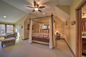 een slaapkamer met een hemelbed en een plafondventilator bij Eagle View Lodge - Luxury Home with Hot Tub! in Waynesville