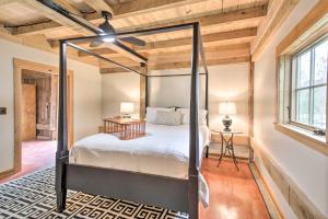 a bedroom with a four poster bed and a ceiling fan at Bloomington Cabin 4 Mi to Indiana University in Bloomington