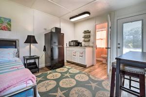 a room with a bed and a kitchen with a refrigerator at Flirty Flamingo Studio 1 Mi to Canyon Lake in Canyon Lake