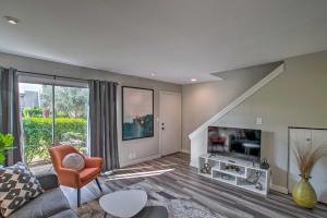a living room with a couch and a tv at Condo 1 Mi to Old Town Scottsdale and Golfing in Scottsdale