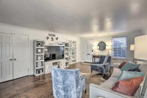 a living room with a couch and chairs and a tv at Central Thomasville Condo - Walk to Broad St! in Thomasville