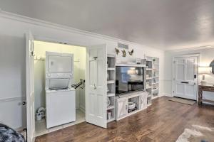 a living room with white cabinets and a tv at Central Thomasville Condo - Walk to Broad St! in Thomasville