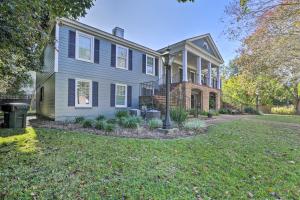 a large house with a yard with a house at Central Thomasville Condo - Walk to Broad St! in Thomasville