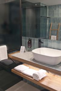 a bathroom with a large white bath tub on a counter at Aparthotel El Cargol in L'Escala