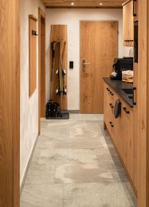 a kitchen with wooden cabinets and a tile floor at The VIEW - KAPRUN in Kaprun